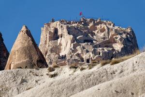 View of Uchisar Castle in Cappadocia, Turkey. Uchisar Castle is a tall volcanic-rock outcrop and is one of Cappadocia's most prominent landmarks. photo
