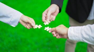Business hand-holding jigsaw puzzle With the cooperation of business people team joins together to campaign Environment, Society and Corporate Governance. Sustainable corporate social, environmental photo