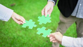 Business hand-holding jigsaw puzzle With the cooperation of business people team joins together to campaign Environment, Society and Corporate Governance. Sustainable corporate social, environmental photo