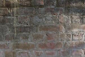 a man is standing on a wall with a skateboard photo