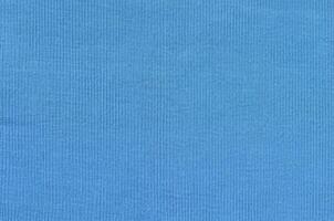 The texture of the fabric in blue color. Material for making shirts and blouses photo