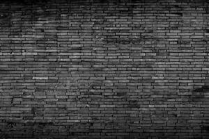 Black brick walls that are not plastered background and texture. The texture of the brick is black. Background of empty brick basement wall. photo