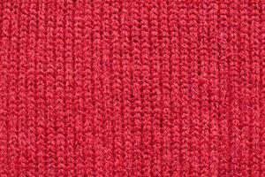 Red knitted wool fabric texture background photo