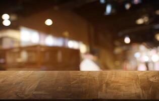 Empty dark wooden table in front of abstract blurred bokeh background of restaurant . can be used for display or montage your products.Mock up for space. photo