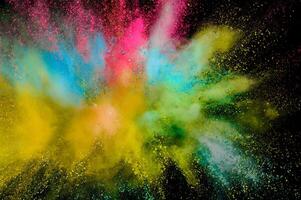 Colored powder explosion. Abstract closeup dust on backdrop. Colorful explode. Paint holi photo