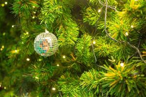 Bright and abstract blurred colorful on Christmas tree with shimmering glitter, defocused background photo