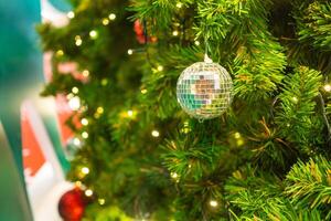 Bright and abstract blurred colorful on Christmas tree with shimmering glitter, defocused background photo