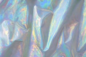 trendy holographic background.Silver metallic iridescent background.pastel colored  holographic texture in pink violet, Silver and  green colors.colorful chrome fabric.I photo