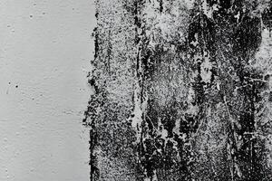 Abstract grunge texture pattern of black paint on white wall photo