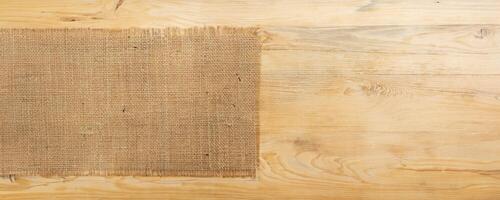 burlap hessian sacking on wooden background photo