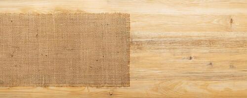 burlap hessian sacking on wooden background photo