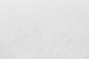 Uniform snow cover. Snow texture on a flat plot of land photo