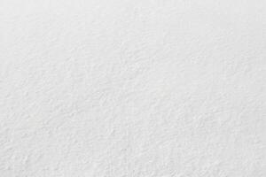 Uniform snow cover. Snow texture on a flat plot of land photo