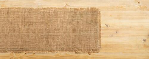 burlap hessian sacking on wooden background photo