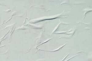 A sheet of white crumpled paper. Abstract background for design. photo