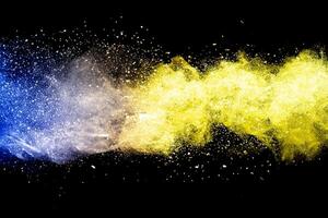 Explosion of multicolored dust on black background. photo