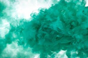 Green smoke bomb exploding against white background photo