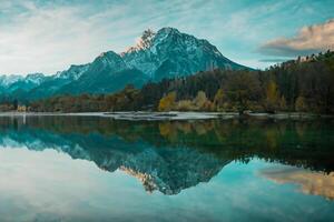 Beautiful lake jasna in kranjska gora with visible reflections of Razor and Skrlatica in the water in early autumn photo