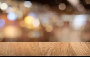 Empty dark wooden table in front of abstract blurred bokeh background of restaurant . can be used for display or montage your products.Mock up for space. photo