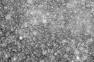 Snowflakes against black background for adding falling snow texture into your project. Add this picture as Screen mode layer in photo editor to add falling snow to any image.