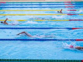 Young men swimmers in the competition. Concept of sport photo