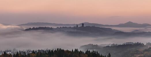 Panoramic foggy landscape at dawn over mountain and valley photo