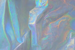 trendy holographic background.Silver metallic iridescent background.pastel colored  holographic texture in pink violet, Silver and  green colors.colorful chrome fabric.I photo