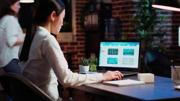 Worker looks over statistical data financial graphs on laptop screen, researching key data for company project. Businesswoman analyzing stock market figures and charts on electronic device, camera B video