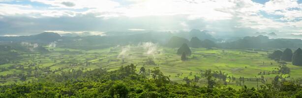 Panoramic foggy landscape with mountains in morning photo