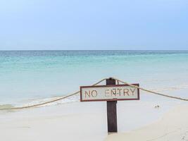 Landscape of the sea with No Entry sign on the beach at Koh Mai Thon, Phuket, Thailand. photo