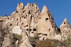 View of an old troglodyte settlement in Uchisar. Travel concept for Cappadocia. photo