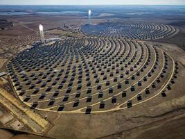 Aerial view of the Solar Power Towers PS10 and PS20 in Sanlucar la Mayor, Seville. Spain's stunning solar energy plant. Concentrated solar power plant. Renewable energy. Green energy. photo