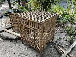 a small cage with a wooden top and bars photo