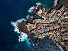 Aerial view of Punta Brava in Tenerife, Canary Island, Spain. Colorful houses and black lava rocks in a small fisherman village. Island in the Atlantic ocean. photo