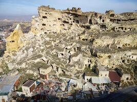 Aerial drone view the old troglodyte settlement of Cavusin, in Cappadocia, Turkey. This location is part of the Goreme National Park and the Rock Sites of Cappadocia inscribed as a Unesco site. photo
