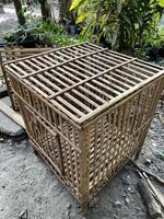 a small cage with a wooden top and bars photo