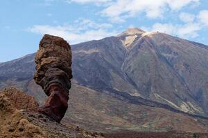 View of Mount Teide, with Roque Cinchado in the foreground. Roque Cinchado is a volcanic rock formation regarded as the symbol of the island of Tenerife, Canary Islands, Spain. Teide National Park. photo