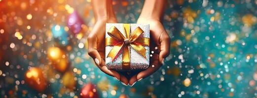 AI Generated Hands hold a vibrant gift box with a golden bow, surrounded by a colorful bokeh effect. Panorama with copy space. photo