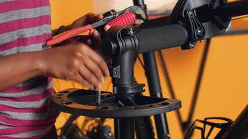 Close up shot of repairman preparing work tools before starting mending broken customer bicycle, studio background. Expert arranging mechanical gear, ready to start servicing bike, camera A video