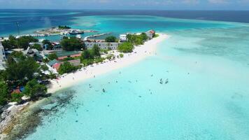 antenne visie van eiland in de buurt maafushi Aan kafu atol. tropisch eiland met Doorzichtig oceaan en strand, Maldiven video