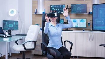 Female physician using virtual reality goggles in a futuristic clinic for neurology. Modern medicine. video