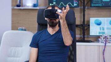 Man wearing virtual reality goggles in a neuroscience laboratory making hand gestures. video