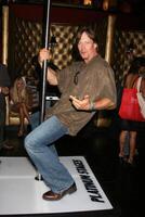 Kevin Sorbo demonstrating his moves on the Platinum Stages stripper pole GBK MTV Movie Awards Gifting Suites  Crimson  Opera Los Angeles,  CA May 30, 2008 photo