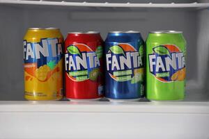 KYIV, UKRAINE - 4 MAY, 2023 Fanta soft drink brand tin cans with various flavours photo