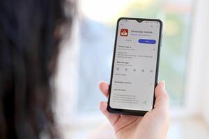 TERNOPIL, UKRAINE - AUGUST 3, 2023 Santander bank application on screen on modern smartphone. Official app of famous polish bank photo