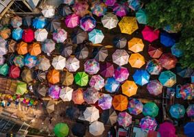 AI generated There are many umbrellas in many colors. A bunch of umbrellas that are on the ground photo