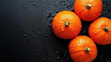 ai generado vibrante naranja calabazas con agua gotas en un negro fondo, un Fresco otoñal seducir, ai generado. foto