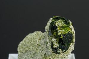 macro mineral stone Andradite on a black background photo