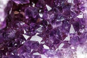 Macro Mineral Stone Amethysts in the rock on a white background photo