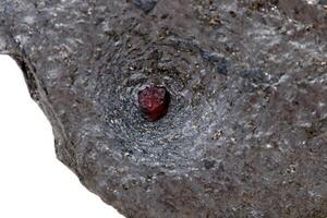 Macro mineral stone garnet  in the rock on a white background photo